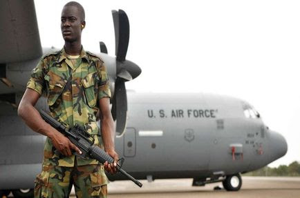 A member of the Ghanaian air force guards a U.S. Air Force C-130J Hercules