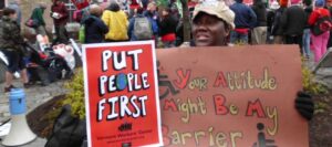 Protest sign: "Put People First"