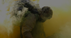 A soldier in a cloud of war