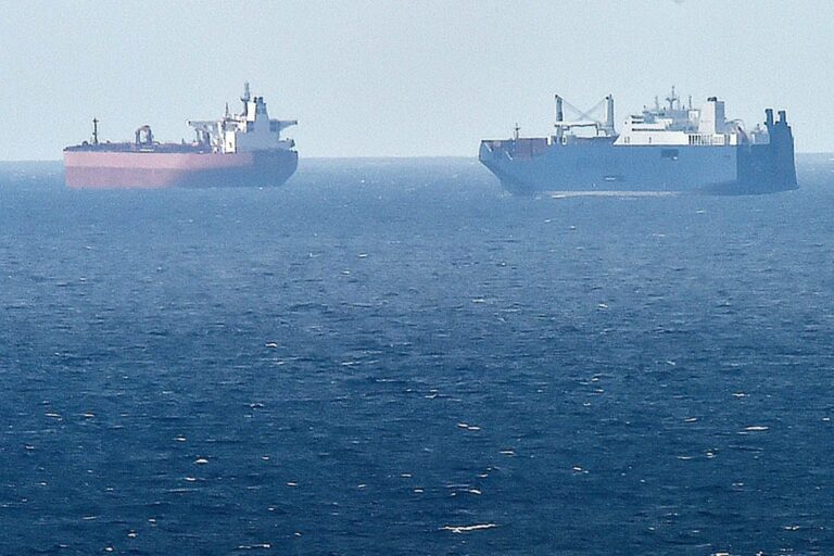 A picture taken on May 9, 2019 from northern port of Le Havre, shows Saudi cargo ship Bahri Yanbu (R) next to British crude oil tanker Nordic Space (L) waiting in the port of Le Havre. - French President defended his country's arms sales to Saudi Arabia and the United Arab Emirates on 9 May 2019