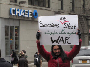Protestor: "Sanctions are Silent War"