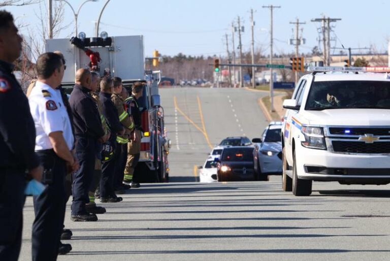 Police, firefighters and emergency personnel line Garland Avenue in Burnside as the body of RCMP Const. Heidi Stevenson is transported on Sunday evening. - Eric Wynne