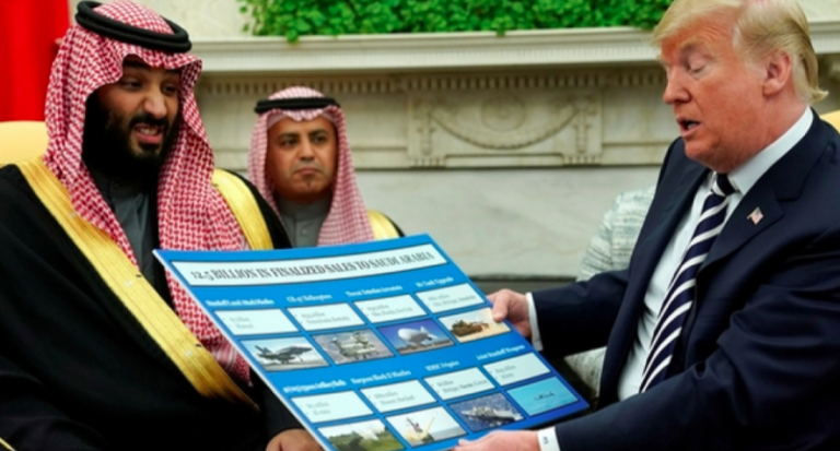 Trump holds a chart of weapon sales as he welcomes Mohammed bin Salman in the Oval Office, March 20, 2018. (Photo: Reuters)