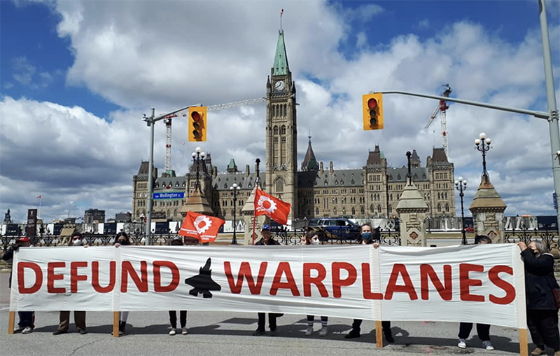 protest banner - defund warplanes