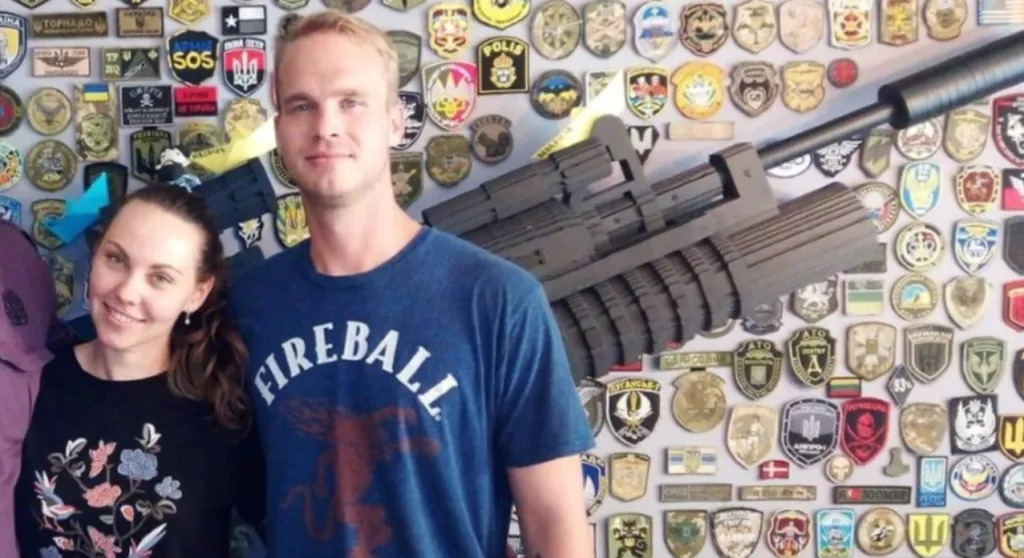 craig lang in front of wall of fascist badges