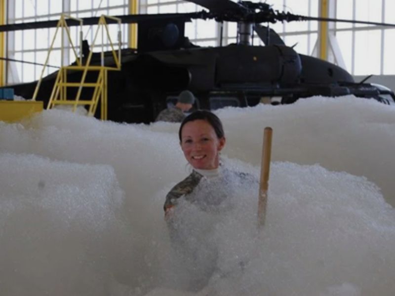 A military helicopter covered in foam
