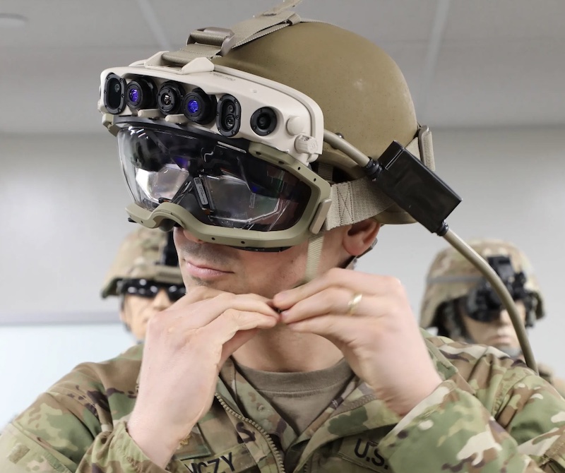 Soldier wearing a heavy headset with goggles and cables