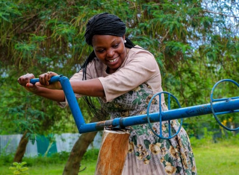 Sellah King'oro operating a machine on a farm