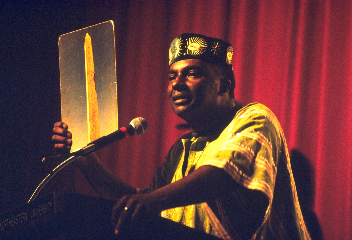 Leonard Jeffries holding a picture of an obelisk