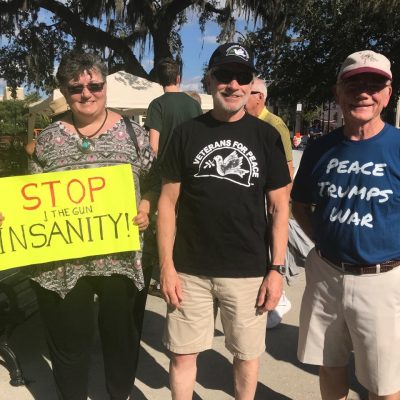 Central Florida chapter members pose with a sign that says "Stop the Gun Insanity"